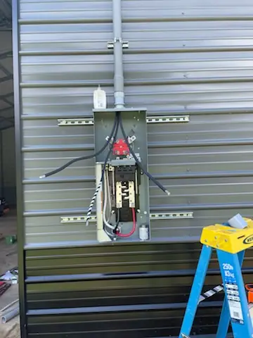 Electrical panel installation in the Asheville area: a clean subpanel setup mounted and wired for a new outbuilding